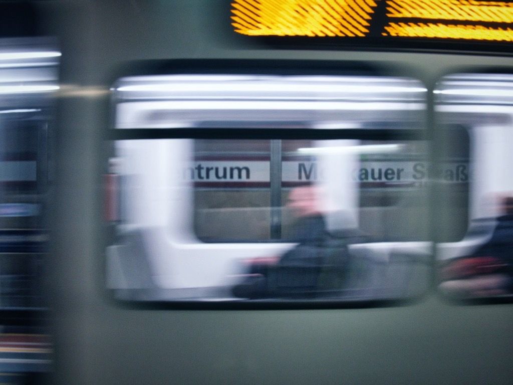 Blurred Dusseldorf U-Bahn train passing through an underground station platform