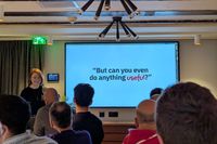 Julia Miocene speaking at css cafe with a slide behind her: But can you do anything useful?