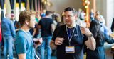Me talking to Joey at CSS day, both have coffee in hands.