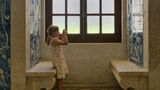My daughter taking pictures of azuleas in Lisbon in an ol cloister