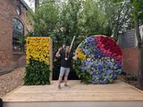 Me doing peace signes in front of an I/O logo with flowers