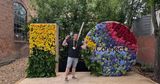 Me doing peace signes in front of an I/O logo with flowers