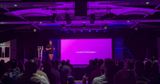 Me presenting on the Middlesbrough front end stage, purple lights and slide