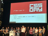 All speakers on stage at CSS day, behind them there is a slide indicating the edition next year will be 11th and 12th of june